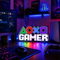 Lampe LED gamer PlayStation de LampeGeek avec éclairage RGB pour setup gaming, visible sur fond noir.